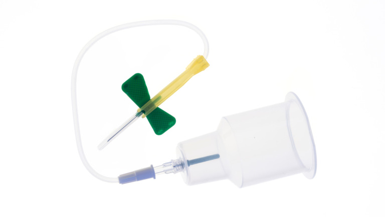Winged blood collection set with luer adaptor and holder